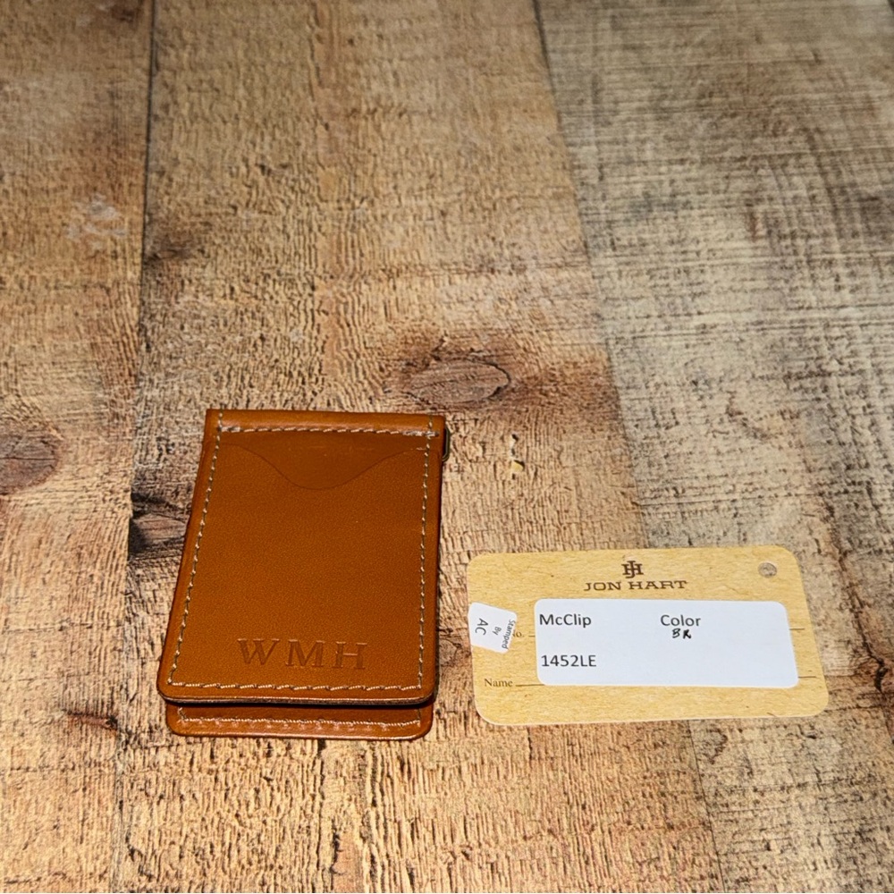 Jon hart mcclip 
Brown color 
monogram WMH